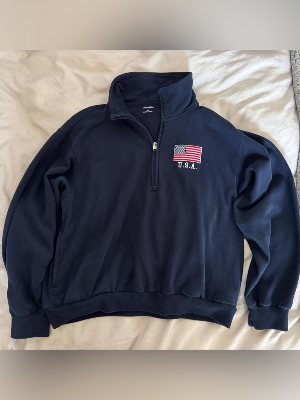 Navy blue Hollister Co. quarter zip sweatshirt with USA flag patch, size M